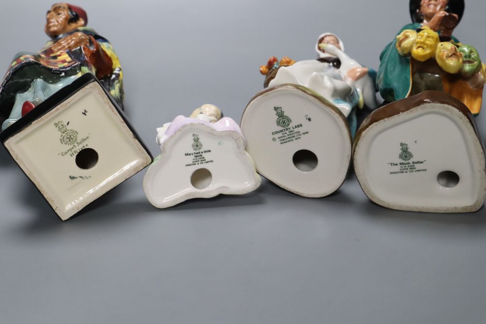 Four Royal Doulton figures, Carpet Seller, Mask Seller, Country Lass, Mary had a Little Lamb